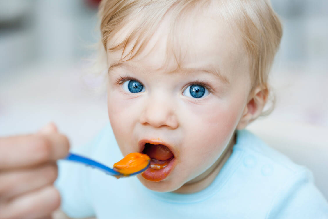 Spätestens ab dem sechsten Lebensmonat sollte das Baby festere Nahrung bekommen. Die Beikost wird dann Schritt für Schritt aufgebaut.  / Foto: Getty Images / Emely