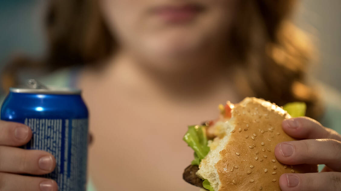 Das Risiko für eine MASLD steigt durch eine ungesunde Ernährung mit vielen Kohlenhydraten, gesättigten Fettsäuren und fructosereichen Softdrinks. / © Getty Images/Motortion