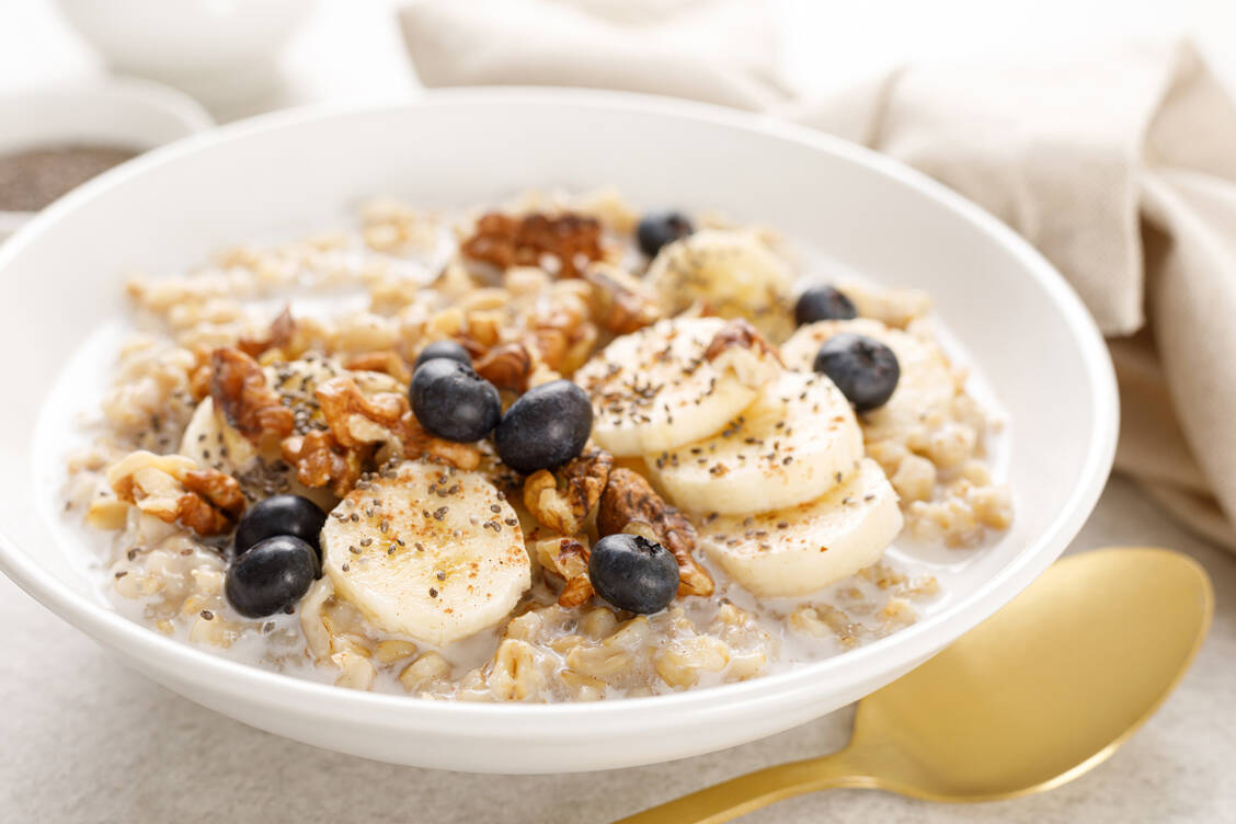 Reichhaltiges Frühstück: Wer mit Porridge, Obst und Nüssen in den Tag startet, kann gleich ein dickes Plus auf dem Ballaststoffkonto verbuchen. / Foto: Getty Images/YelenaYemchuk