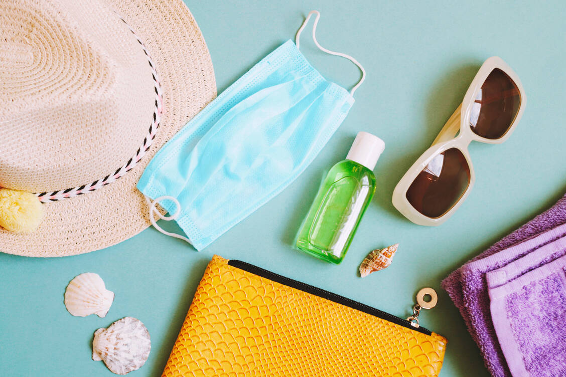 Sollten inzwischen zur Standardausrüstung im Sommerurlaub gehören: Mund-Nasen-Schutzmasken, Schnelltests und Desinfektionsmittel. / Foto: Getty Images/leares